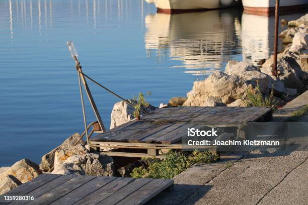 Medulin Pomer Istria Croatia Palette And Flowers At The Jetty Stock Photo - Download Image Now
