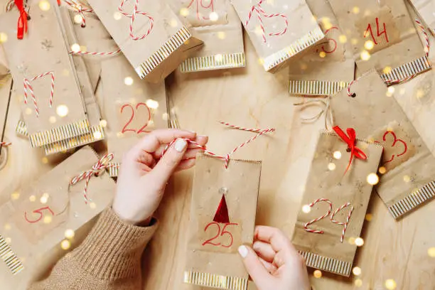 Handmade advent calendar on a wooden background with a place to write