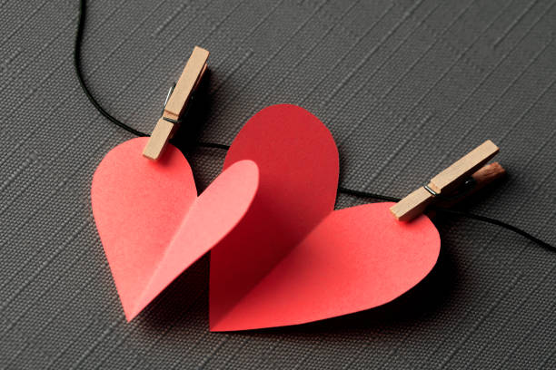 istock Two paper hearts on a clothesline with space for copy 1359283560