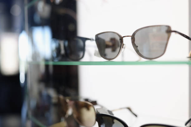 istock Stylish sunglasses lying on showcase in store closeup 1359286380