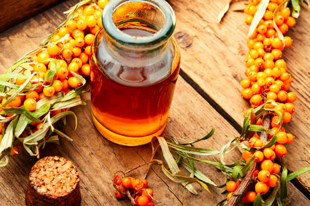 istock Sea buckthorn in glass bottle 1359293346