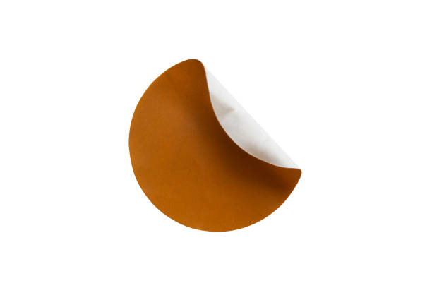 istock Brown round paper sticker label isolated on white background 1359295027