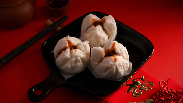 istock Steamed red minced pork buns on a plate. Chinese appetiser concept. 1359295140