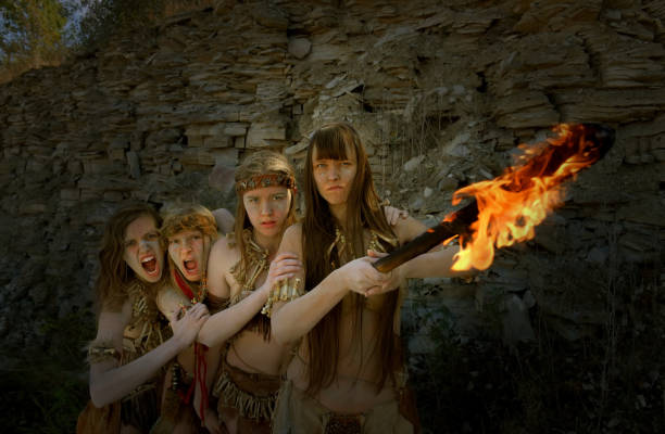 istock Angry Neanderthal Girls With A Blazing Torch 1359296808