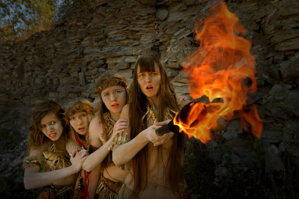 istock Angry Neanderthal Girls With A Blazing Torch 1359296841