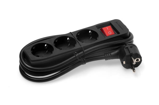 istock Black connector strip with coiled cable and glowing red on / off switch against a white backgroundblack connector strip with coiled cable and glowing red on / off switch against a white background 1359299396