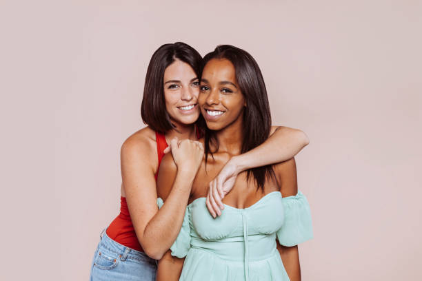 istock Two multiracial female friends hugging at studio 1359300283