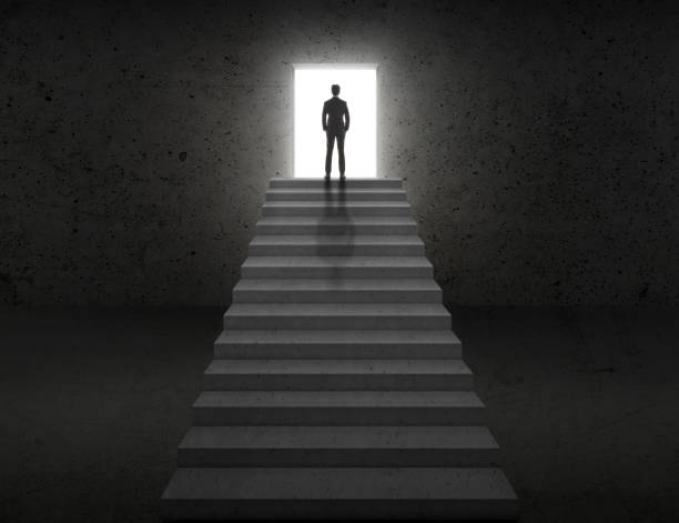 istock Vision concept. Successful businessman standing on staircase 1359300726