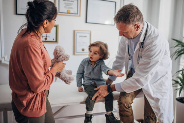 istock Doctor examining a boy 1359302451