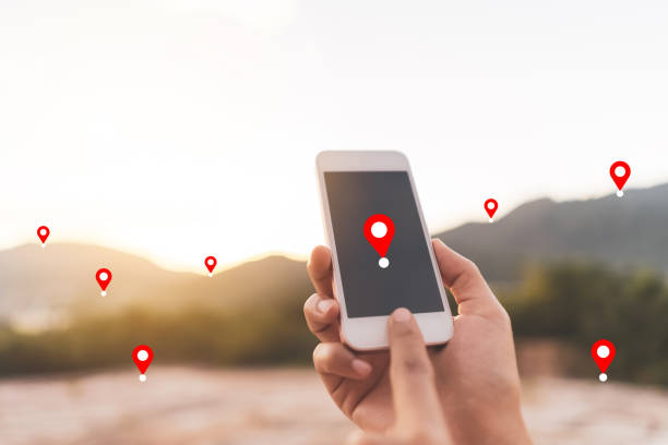 istock Man hand using smart phone on top of mountain with navigator location point abstract background. Technology business and travel adventure concept. 1359305245