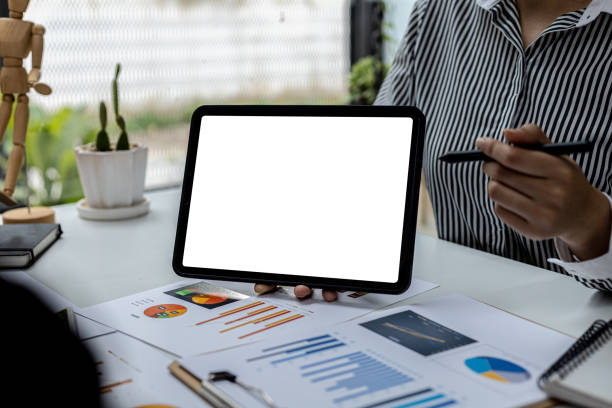 istock Person holding a tablet and having a meeting, on a blank white background tablet screen for illustration, mockup screen for further editing can be used for a variety of tasks. copy space. 1359307053
