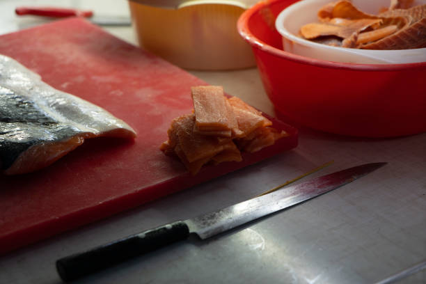 Sushi blanks on the table. Knife and pieces of red fish
