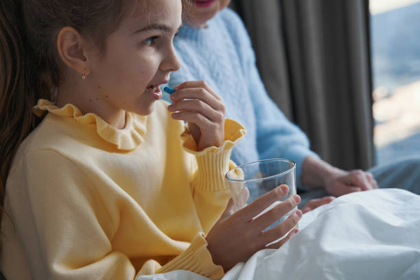 istock Well-behaved little girl taking medication for her sickness 1359307352