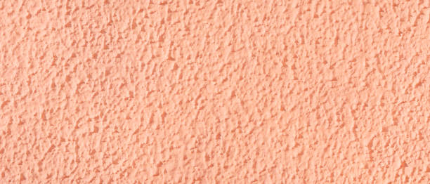 istock Textured surface coat plaster walls pink color. 1359307945