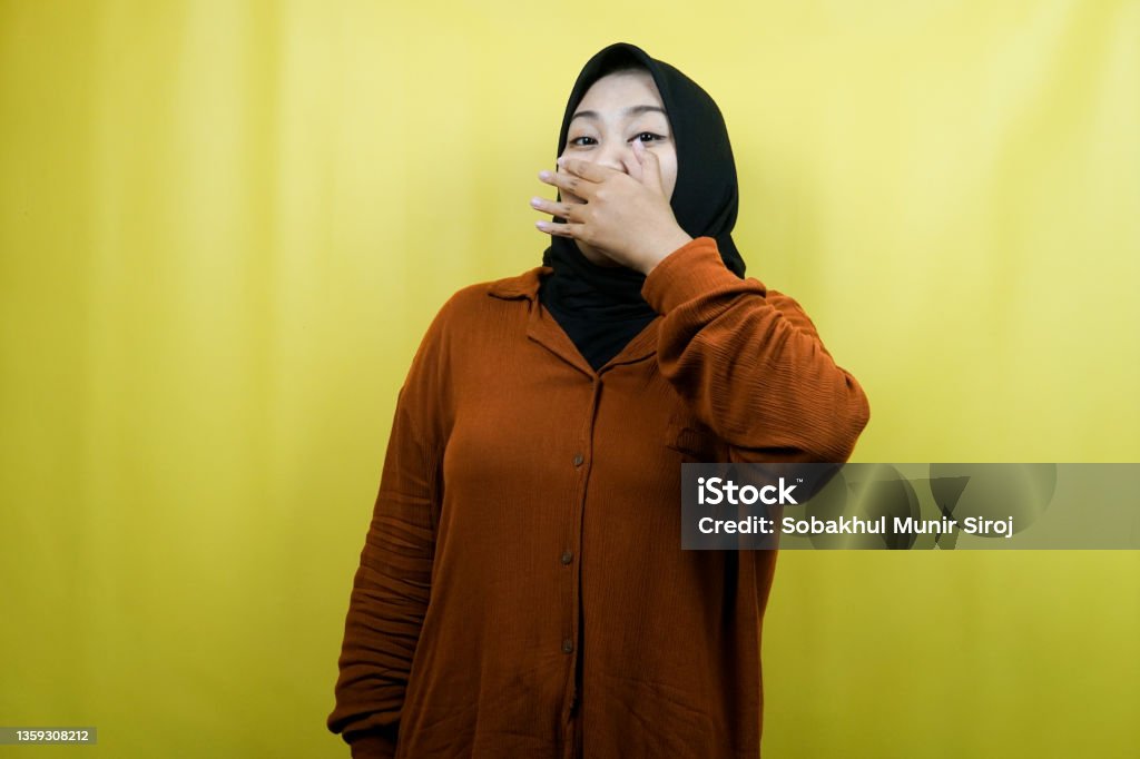 Beautiful young asian muslim woman surprised, shocked, with hands covering mouth, isolated 20-24 Years Stock Photo
