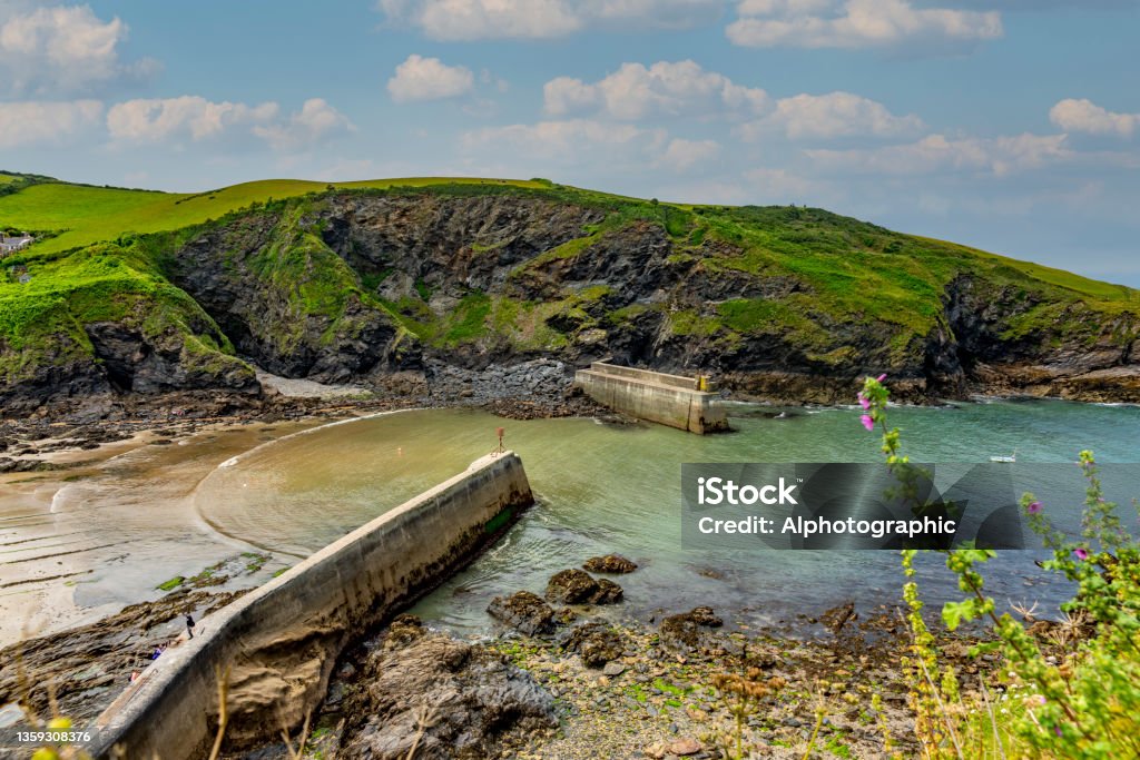 The Cornish coast at the entrance to Port Isaac harbour The Cornish coast at the entrance to Port Isaac harbour.  Port Isaac is the location for the fictional Port Wen in the TV series 'Doc Martin'. Beach Stock Photo
