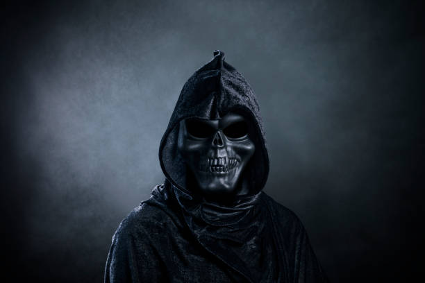 istock Grim reaper over dark misty background 1359309460