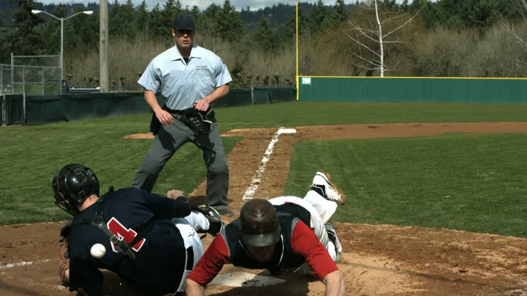 Baseball players collide at home plate