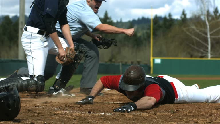 Baseball player slides into home plate, slow motion