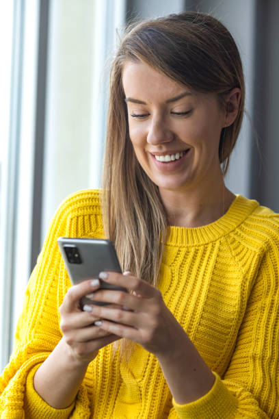 istock Smiling businesswoman using phone in office. 1359310561