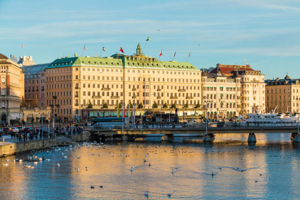 Strombron Bridge and Norrstrom River in Stockholm Stockholm, Sweden - December 26, 2018: Panoramic view of the Strombron Bridge and historic buildings on embankment of the Norrstrom River in sunny winter day strommen stock pictures, royalty-free photos & images