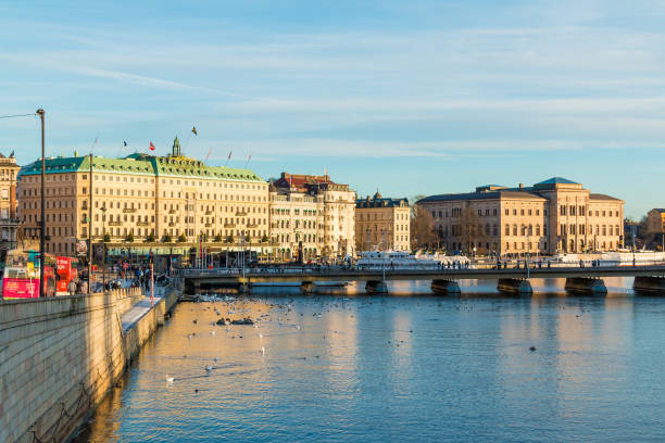 Strombron Bridge and Norrstrom River in Stockholm Stockholm, Sweden - December 26, 2018: Panoramic view of the Strombron Bridge and historic buildings on embankment of the Norrstrom River in sunny winter day strommen stock pictures, royalty-free photos & images