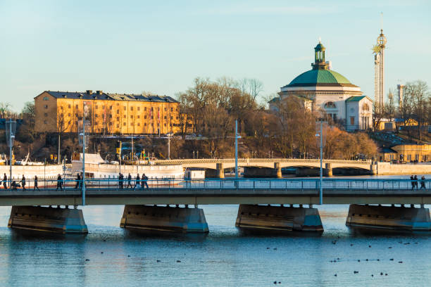 Strombron Bridge and Norrstrom River in Stockholm Stockholm, Sweden - December 26, 2018: The Strombron Bridge, the Skeppsholmsbron Bridge and historic buildings on embankment of the Norrstrom River in sunny winter day strommen stock pictures, royalty-free photos & images