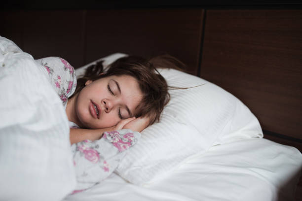 istock Girl sleeping in a hotel bed 1359312122