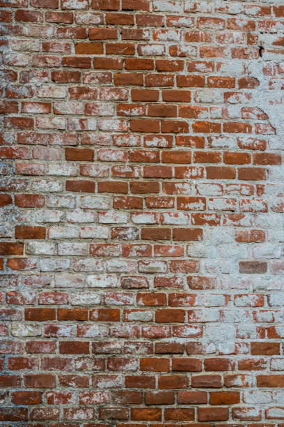 istock Background of old vintage dirty brick wall with peeling plaster, texture 1359313480