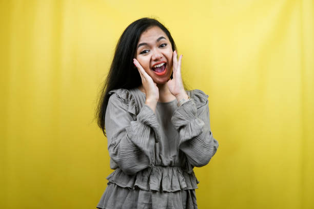 istock Beautiful young woman surprised, shocked, wow expression, presenting something, promoting a product, advertising, isolated 1359314821