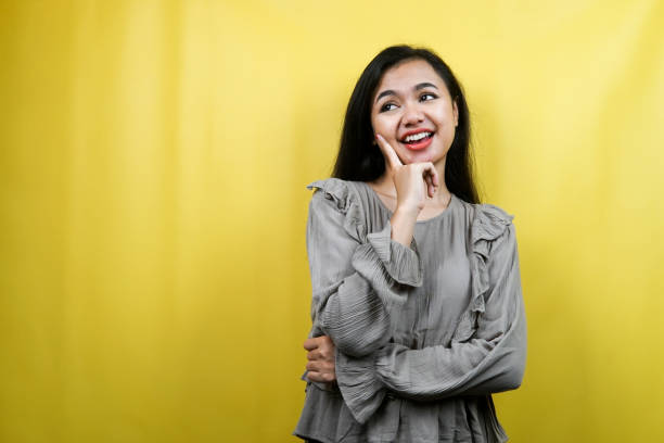istock Beautiful young woman, looking at empty space, presenting something, isolated 1359314883