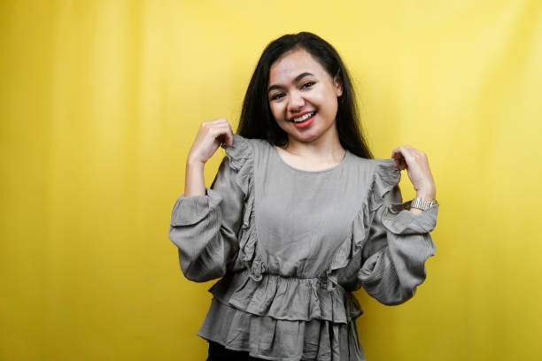 istock Beautiful young woman, with hands showing clothes, isolated 1359314885