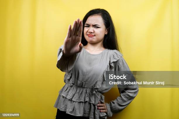 Beautiful Young Woman With Serious Expression Refusing Something Looking At Camera Isolated Stock Photo - Download Image Now