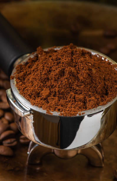 istock Preparing espresso, macro of portafilter with ground coffee 1359314924
