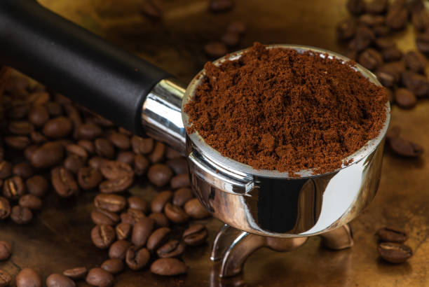 istock Preparing espresso, macro of portafilter with ground coffee 1359315263