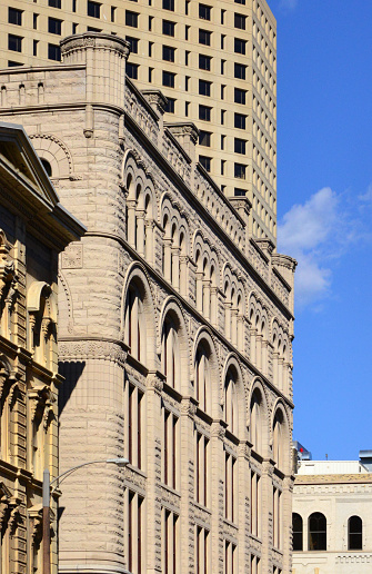 Milwaukee, Wisconsin, USA: Loyalty Building facade on East Michigan Street, designed by Solon S. Beman, Richardsonian Romanesque style with arches and heavy stone masonry - facade with cornice, pilasters, sets of triplet windows, and multicentered arches - aka 611 Building Northwestern, Mutual Life Insurance Company Home Office, Hilton - to the left Grand Avenue Club / Bank of Milwaukee Building to the right 600 N Broadway, McGeoch Building, US Bank Tower and above 411 E Wisconsin Building.