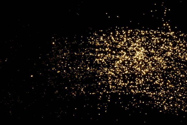 istock Golden blurred bokeh lights on black background 1359315568