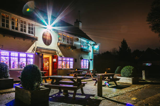 Ifield, UK - 15 December, 2021: color image depicting a quaint, traditional country pub in the old village of Ifield, near Crawley, in the south of England. Night shot with the pub illuminated and decorated with Christmas lights.