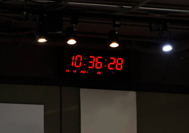 istock Digital clock or time watch display on wall in meeting room for thai people student study looking while learning and training at Bangkok, Thailand 1359321311