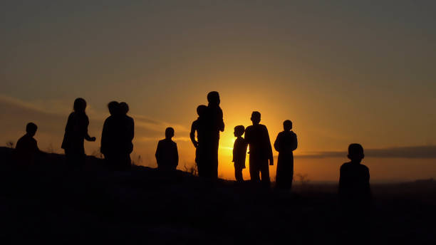 istock silhouettes of people at sunset 1359322170