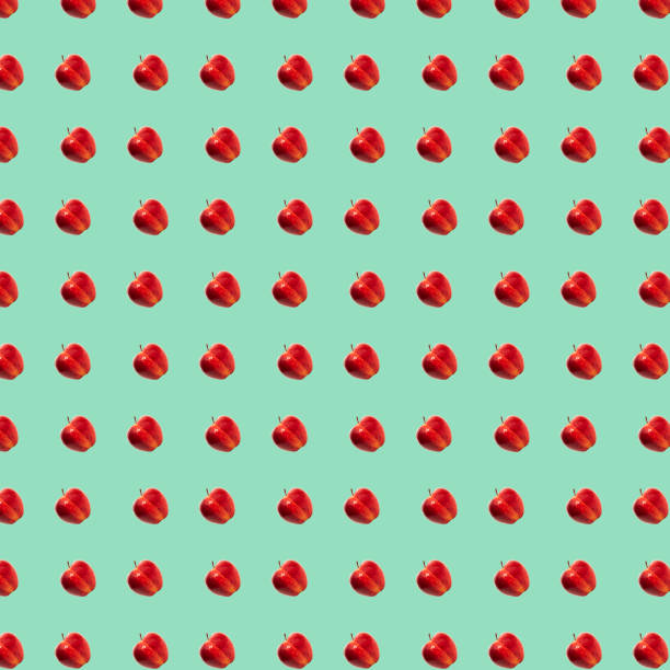 istock Pattern of ripe red apples in green background 1359322846