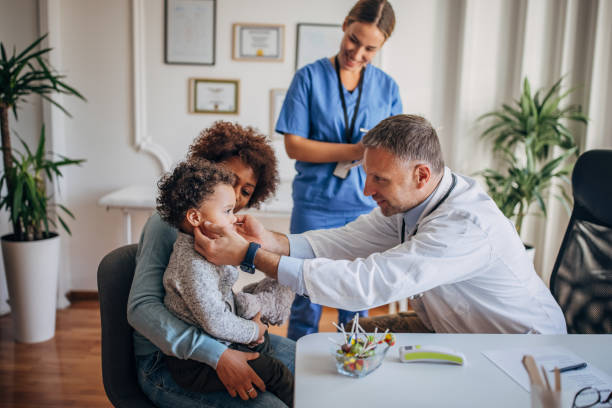 istock Pediatrician examining a boy 1359324240