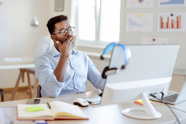 istock Businessman Yawning in the Office 1359326645