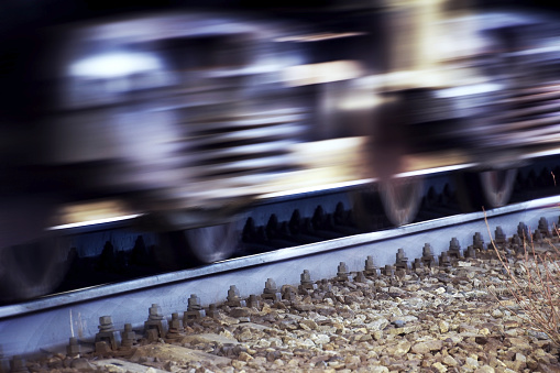 Wheels and springs of a train are rushing along the rails of the Trans-Siberian Railway at high speed