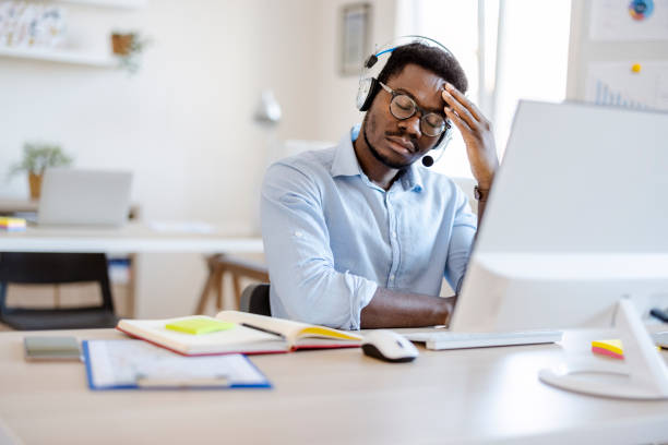 istock Call Center Operator Suffering From Headache or Tired in the Office 1359326751