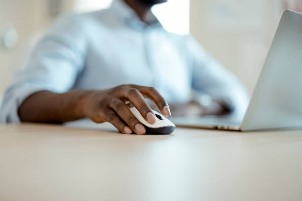 istock Close up of a business man hand using computer mouse 1359327260