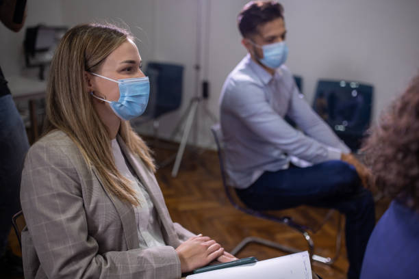 istock Journalists wear protective face mask as a new normal during press conference 1359328504