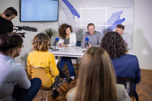 In the media centre, camera-man recording the live press conference Male Caucasian camera-man, recording the press conference, in the media centre interview seminar microphone inside of stock pictures, royalty-free photos & images