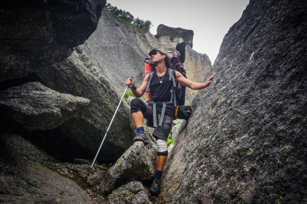 A hiker walks through rocks in the Ergaki Nature Reserve