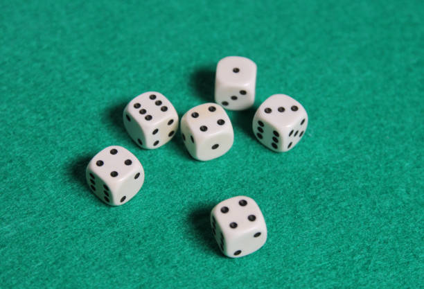 istock White dices on a green mat 1359331525